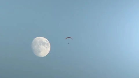 Paraglider sailing in sky with moon Stock Footage 12763598