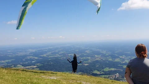 Paraglider Soaring Above Forest Under Blue Sky and White Clouds Over Mountains 스톡 동영상 331853539