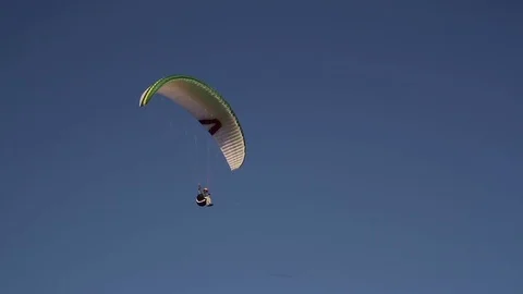 Paraglider soaring in the blue sky Stock Footage 72768513