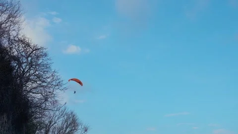 Paraglider Soaring in Clear Blue Sky Stock Footage 293309722