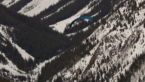 Paraglider soaring in front of mountain Stock Footage 74535926