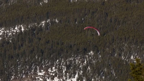 Paraglider soaring in front of mountain Stock Footage 74536285