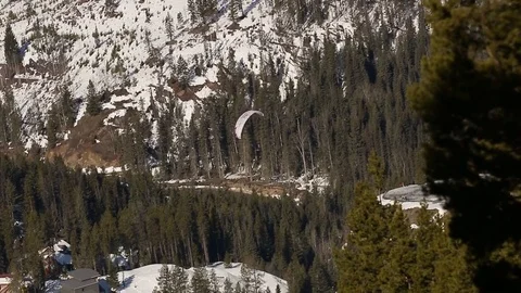 Paraglider soaring in front of mountain Stock Footage 74536288