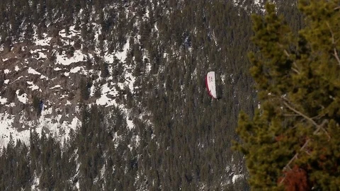Paraglider soaring in front of mountain Stock Footage 74536295