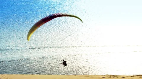 Paraglider Soaring Over a dune during sunset Stockbeeldmateriaal 58728698