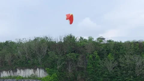 Paraglider Soaring over Limestone Cliffs Bali Indonesia 動画素材 320435909