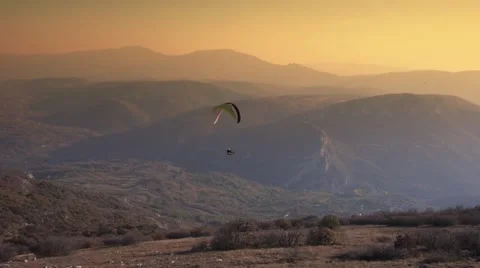 Paraglider Soaring Over The Mountains during sunset Stock Footage 48846449