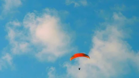 Paraglider soaring through the clouds Stock Footage 89795603