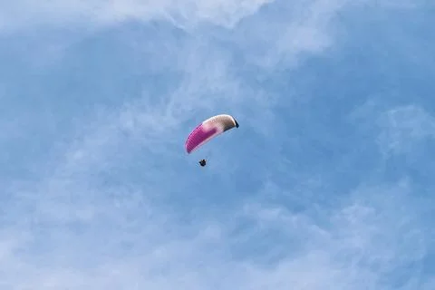 Paraglider soaring through a soft blue sky with wispy clouds over Alanya 写真素材