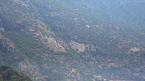 Paraglider soars above open landscape - Paragliding Adventure and Summer Sport Stock Footage 339820352