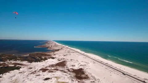 Paraglider soars over beach Stock Footage 72079558