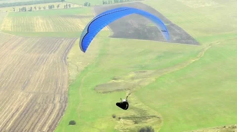 Paraglider soars over fields Stock Footage 62316618