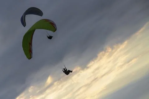 A paraglider soars in the sky at sunset Foto stock