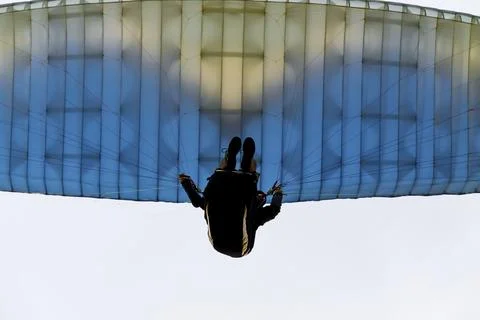 A paraglider soars in the sky at sunset Foto stock