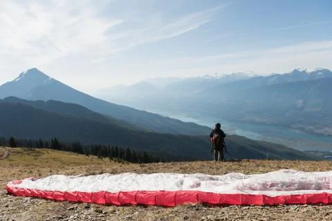 Paraglider standing on mountain Stock Photos