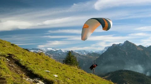 Paraglider starting from top of Chli Aubrig peak close to Einsiedeln Stock Footage