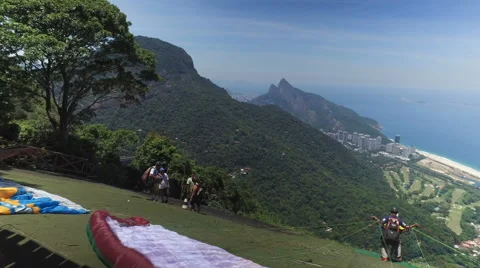 Paraglider take off from the mountain in Rio De Janeiro Stock Footage 61229372