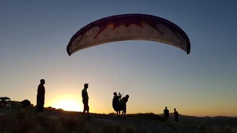 Paraglider take off at sunset Stock Photos