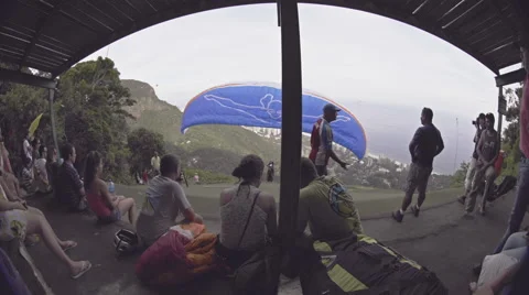 Paraglider takes off in front of spectators Stock Footage 64865322