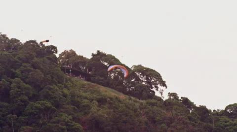 Paraglider takes off in front of spectators Stock Footage 64865433