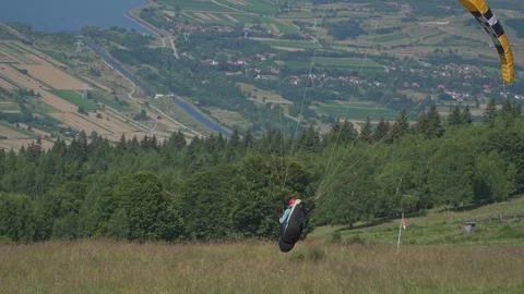 Paraglider Takes Off, Gliding Very Close to the Ground Stock Footage 304663155