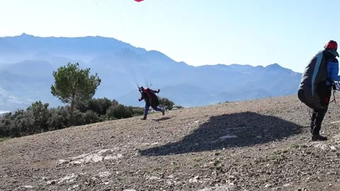 Paraglider taking off from Stock Footage 133648776