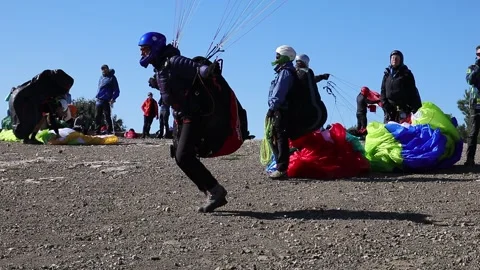 Paraglider taking off from Stock Footage 133648782