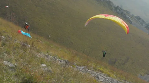 Paraglider taking of hill HD Stock Footage 33091038