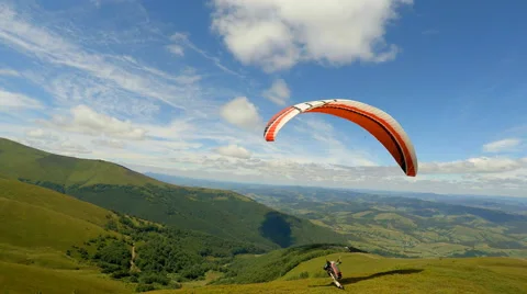 Paraglider taking off from a mountain 스톡 동영상 65382415