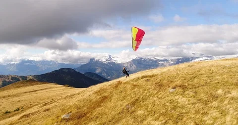 Paraglider taking off from the mountain slope Stock Footage