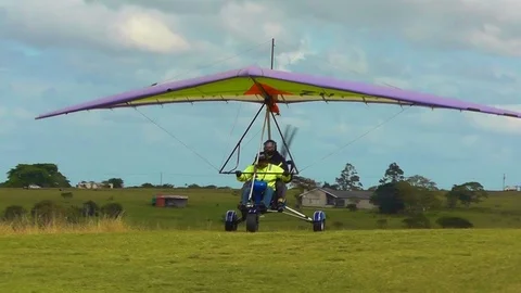 Paraglider taxiing on grass runway in Africa Stock Footage