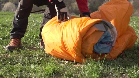 Paraglider unrolling the parachute Stock Footage 76004167