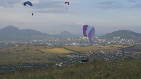 Paragliders on the background of the city Stock Footage 83706086