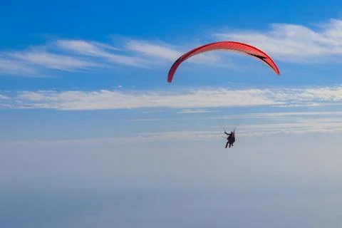 Paragliders in blue sky. Concept of active lifestyle and extreme sport Stock Photos