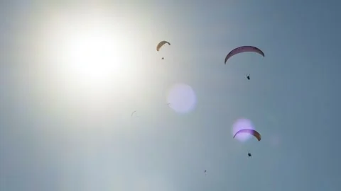 Paragliders in a Clear Blue Sky Stock Footage 282932853