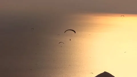Paragliders drift across sunset sky above sea and islands near Fethiye Mugla 库存影片 333846451