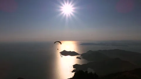 Paragliders drift across sunset sky above sea and islands near Fethiye Mugla Stock Footage 333867505