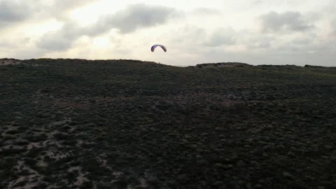 Paragliders explore sunset sky Stock Footage 208872389