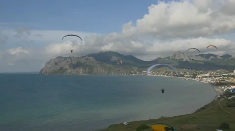 Paragliders fly in the breeze Stock Footage 64618791