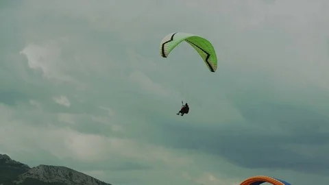 Paragliders fly over the mountains Stock Footage 84548732