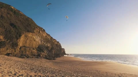 Paragliders Fly Over the Ocean Beach Stock Footage 61357100