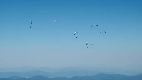 Paragliders fly in the sky Stock Footage 266985657