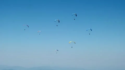 Paragliders fly in the sky Stock Footage 266985708