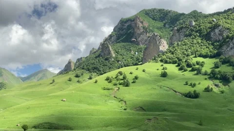 Paragliders flying over meadow in the mountains 스톡 동영상 133894792