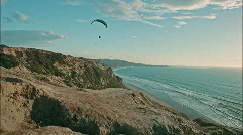 Paragliders flying over ocean Stock Footage 58978029