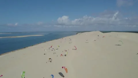 Paragliders getting ready at the Dune of Pilat summit in Arcachon Bay Stock Footage 163489400