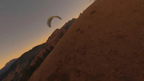 Paragliders Jumping Off Cliffs With A Scenic View Of The Sunset - aerial Video stock 147610503
