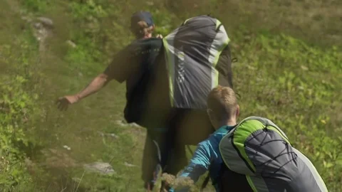 Paragliders running with backpack on hill Stock-Footage 76003274