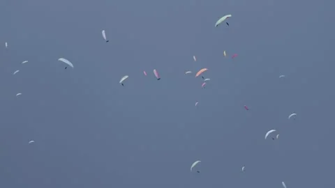 Paragliders skydiving in a circle at a competition. World paragliding cup. Stock-Footage 201835769