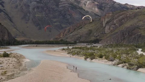 Paragliders soaring above Río de las Vueltas in a glacial valley near El Stock Footage 337124971